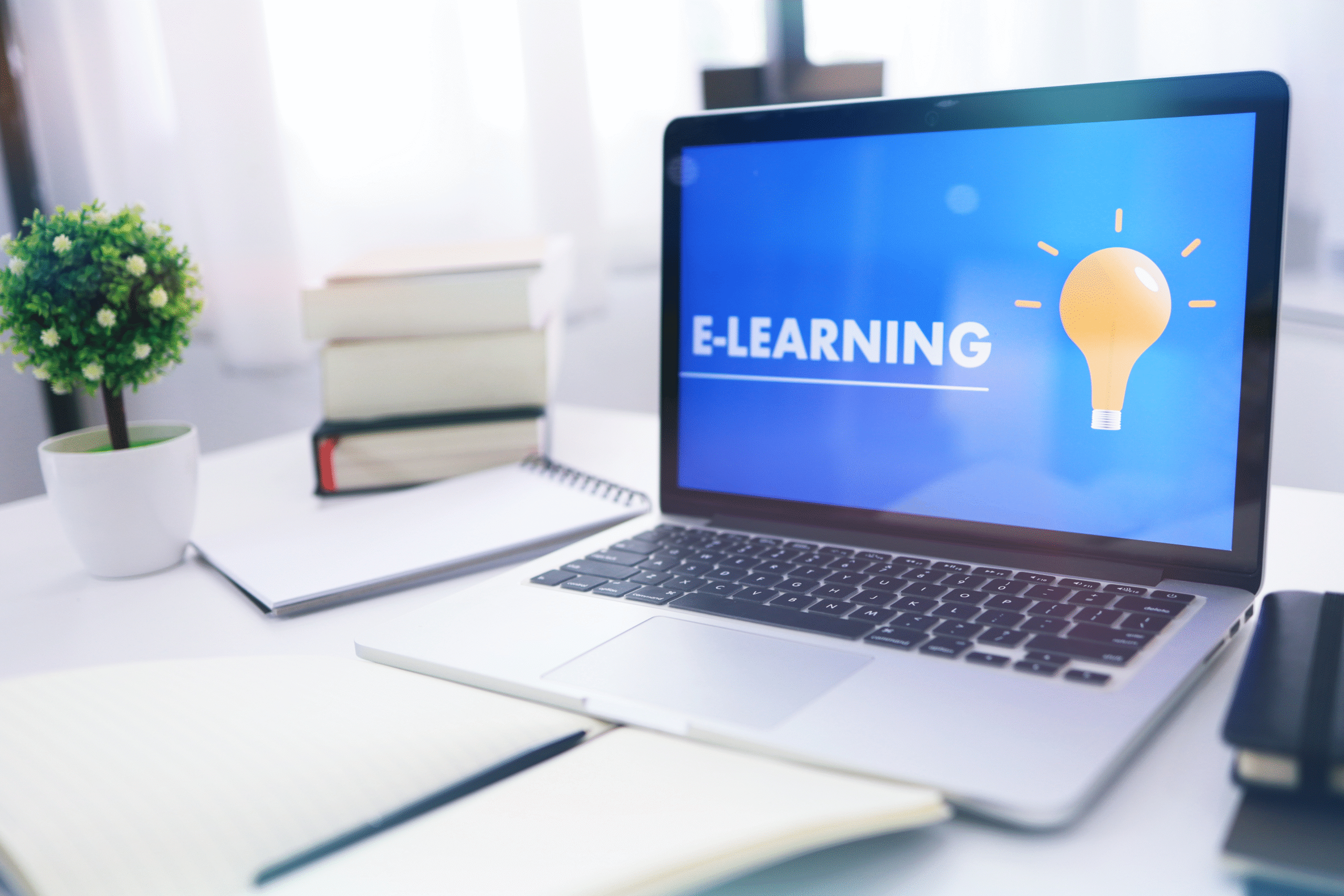 "Laptop displaying an e-learning platform with books and a notebook on a study desk, representing digital learning skills, online education, and flexible learning."